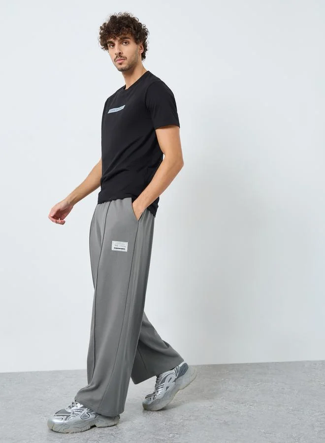 Styli Pintuck Wide Leg Terry Joggers with Badge Detail