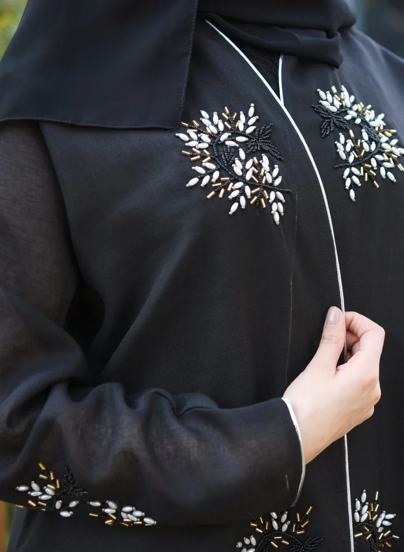 HAWRAA ABAYA Black wrap abaya decorated with prominent embroidery and strings on the edges of the abaya and sleeves