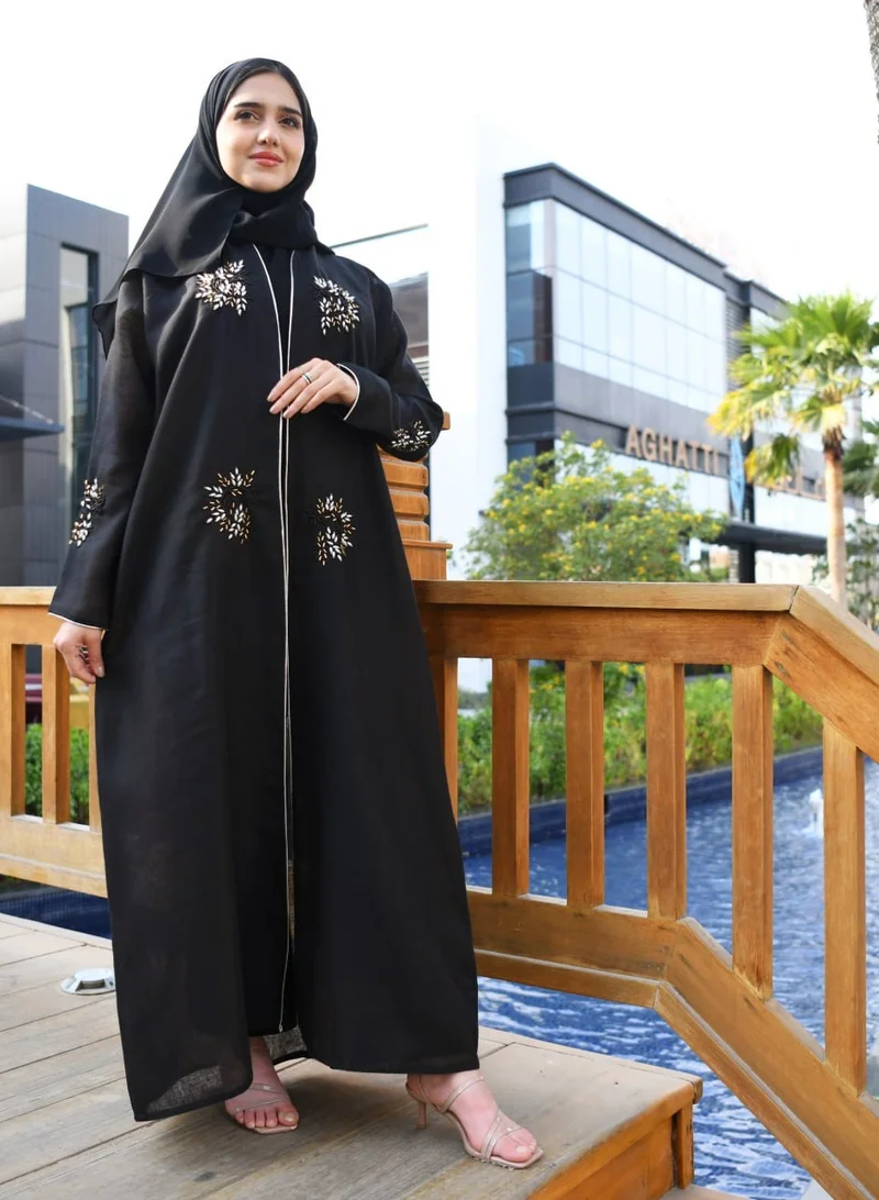 HAWRAA ABAYA Black wrap abaya decorated with prominent embroidery and strings on the edges of the abaya and sleeves