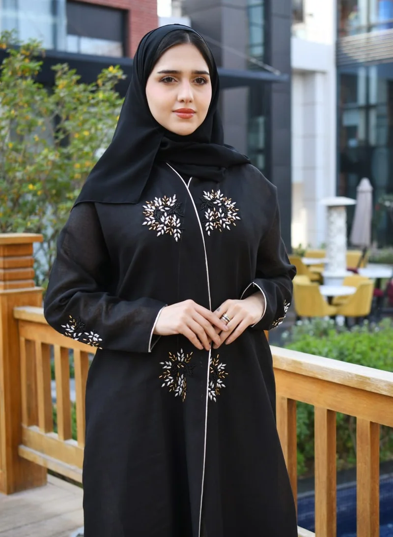 HAWRAA ABAYA Black wrap abaya decorated with prominent embroidery and strings on the edges of the abaya and sleeves