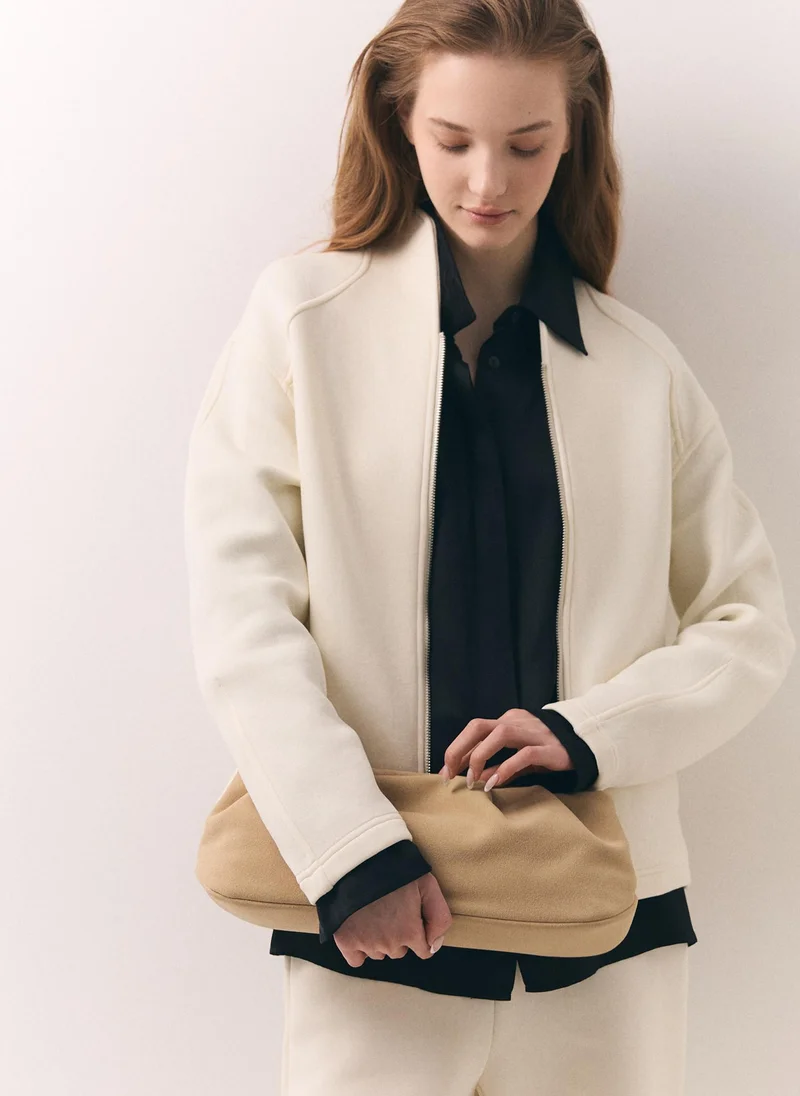 Voluminous eco-leather clutch bag with a thin strap