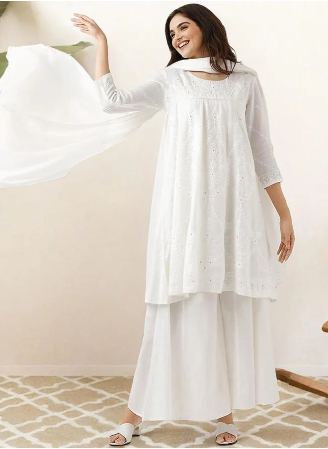 ISHIN Festive Women Off White Cotton Kurta Set with Embroidered pattern Tunic and Palazzo features a Round neckline and Three-Fourth Sleeve secured with Elastic closure and styled in Straight Fit ideal for Festive moments — exude elegance in every glance.