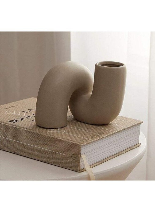 The tilted vase is a piece that combines softness and boldness in one unique design, from simple art and modern elegance to your home or office decor. Beige color.
