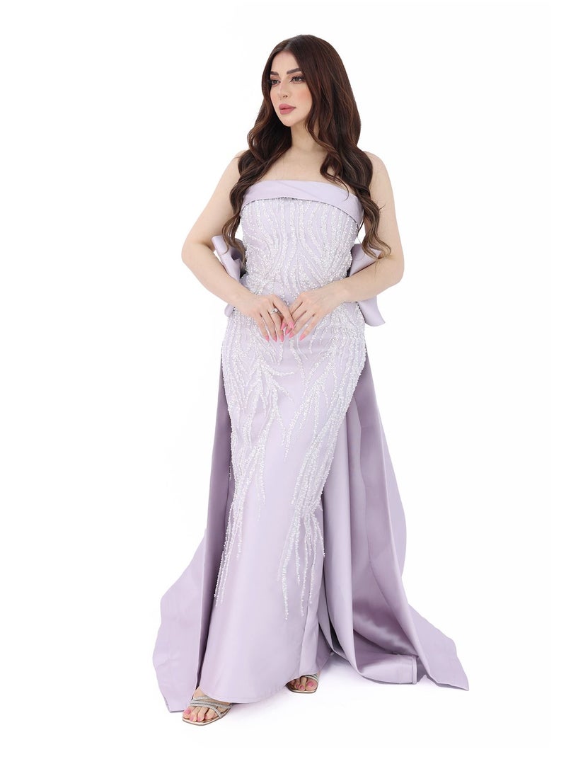 An elegant top evening dress with a back bow in two colors of mauve and tiffany. It features luxurious and elegant embroidery to give you beauty and elegance.