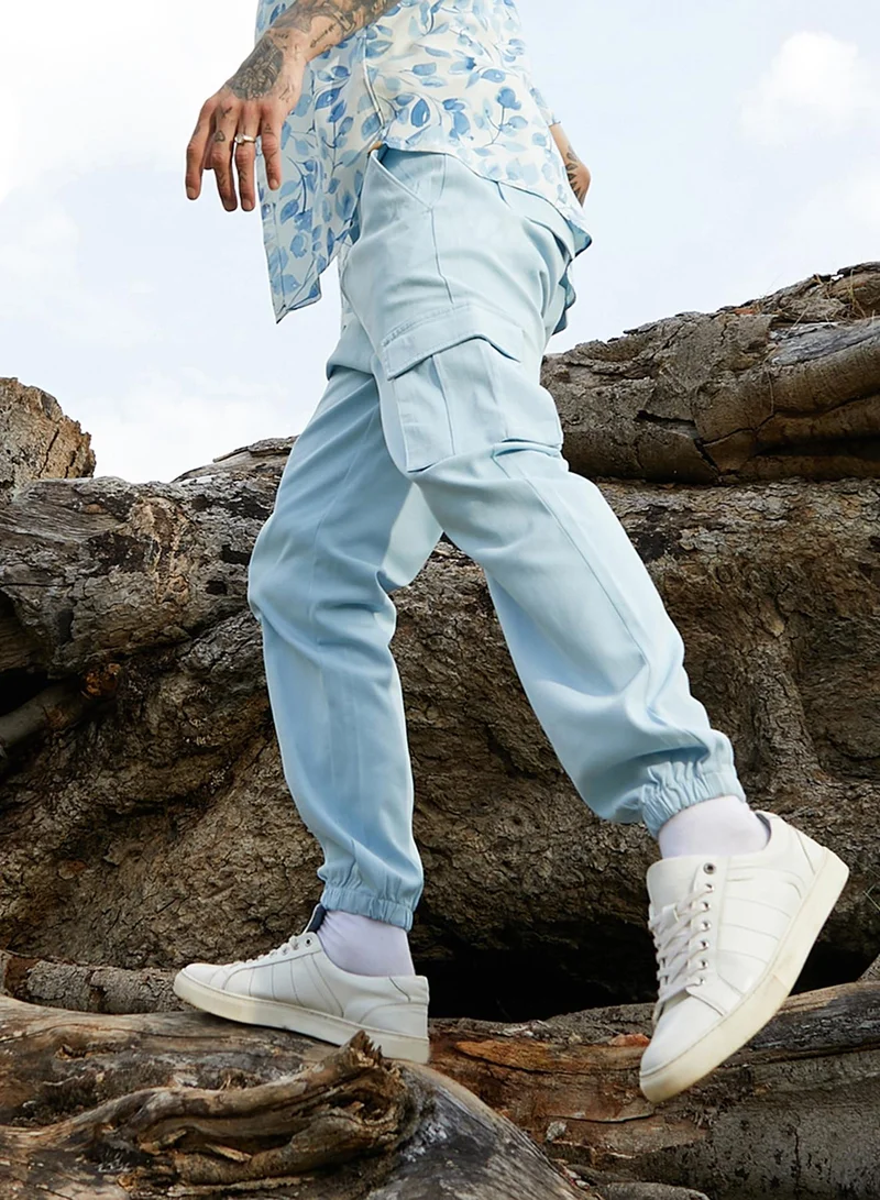 Campus Sutra Campus Sutra Men's Light Blue Cuffed Hem Cargo Trousers For Casual Wear | 6 Pockets | Regular Fit | Button Closure | Cotton Poly Cargo Pant Crafted With Comfort Fit For Everyday Wear