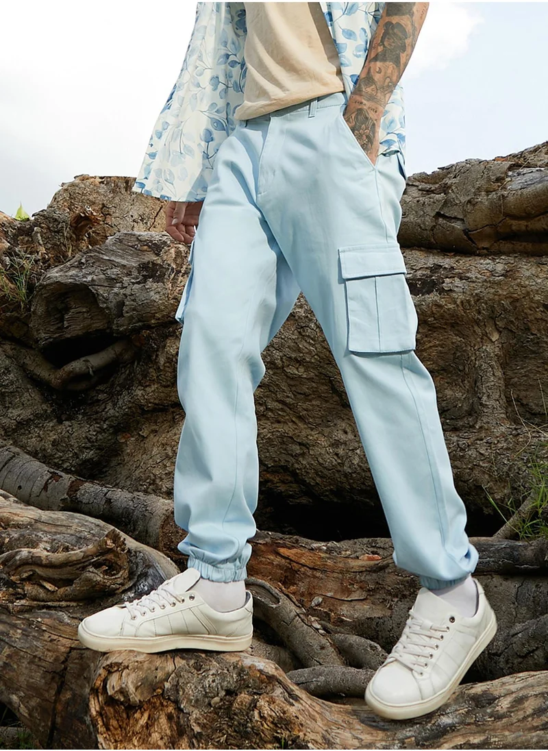 Campus Sutra Campus Sutra Men's Light Blue Cuffed Hem Cargo Trousers For Casual Wear | 6 Pockets | Regular Fit | Button Closure | Cotton Poly Cargo Pant Crafted With Comfort Fit For Everyday Wear