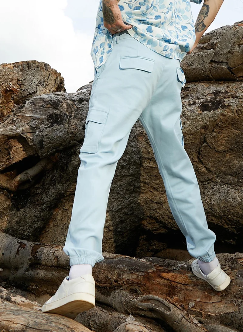 Campus Sutra Campus Sutra Men's Light Blue Cuffed Hem Cargo Trousers For Casual Wear | 6 Pockets | Regular Fit | Button Closure | Cotton Poly Cargo Pant Crafted With Comfort Fit For Everyday Wear