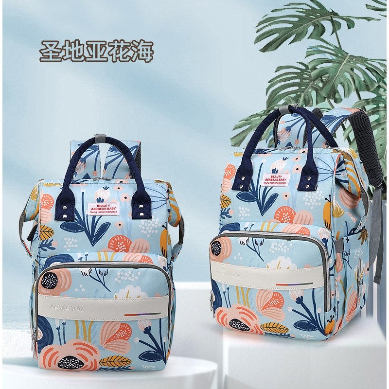 Multi-Functional Baby Diaper Backpack with Floral Design Spacious Storage and Elegant Light Blue Finish