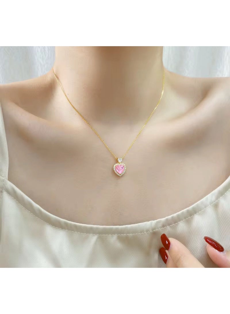 Luxuria An elegant necklace featuring a heart-shaped pendant set with a pink stone, surrounded by a frame of smaller, sparkling stones, on a gold-tone chain. With gemstones such as pink sapphires and zircon. - Image 3