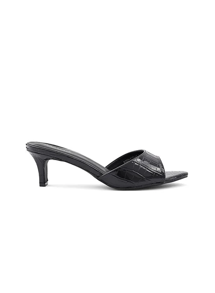 أيقون Glamorous heel slipper with a shimmering surface.