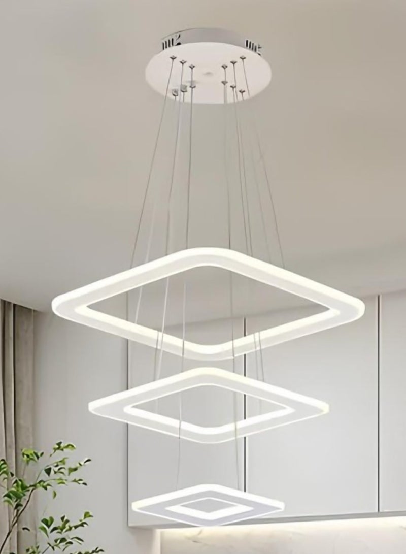 الثريات ثريا بتصميم هندسي يتكون من حلقات LED مربعة ب3 ألوان متدرجة،معلقة بأسلاك رفيعة تمنح الإحساس بالخفة والإنسيابية،تضفي هذه الثريا لمسة فنية ساحرة على المساحات الداخلية،مثالية  لغرفة المعيشة وغرفة الطعام مع جهاز تحكم عن بعد  - Image 2