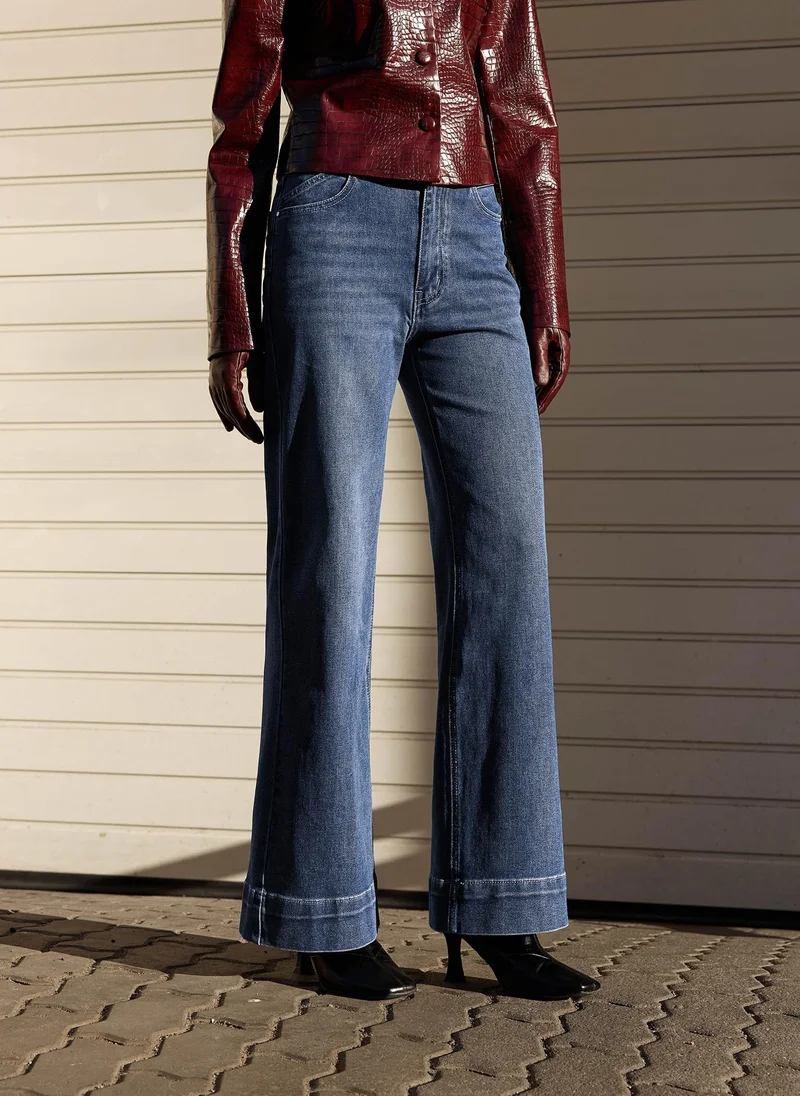 Flared denim jeans with scuffs