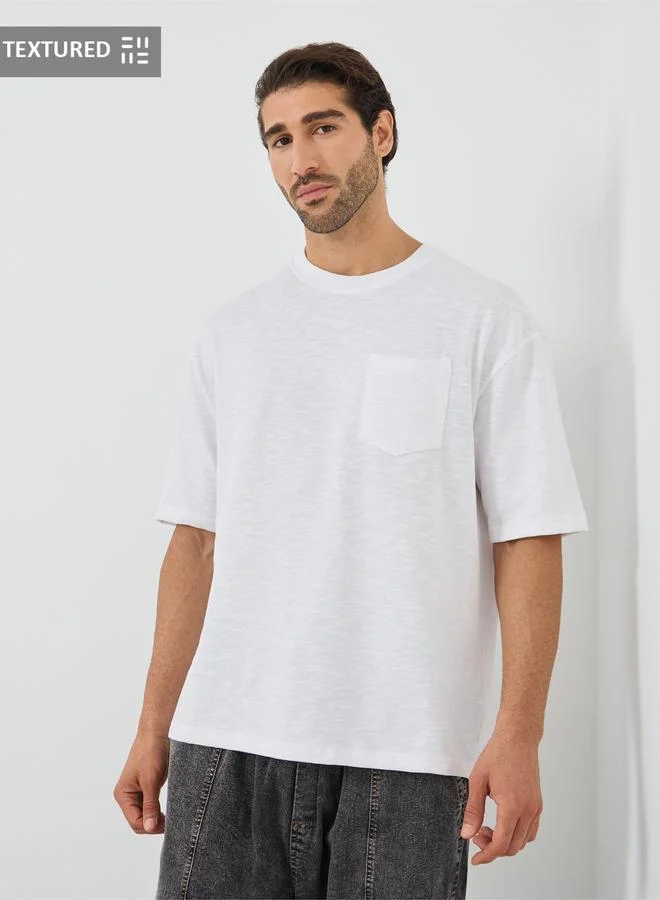 Styli Crew Neck Textured Oversized T-Shirt with Chest Pocket