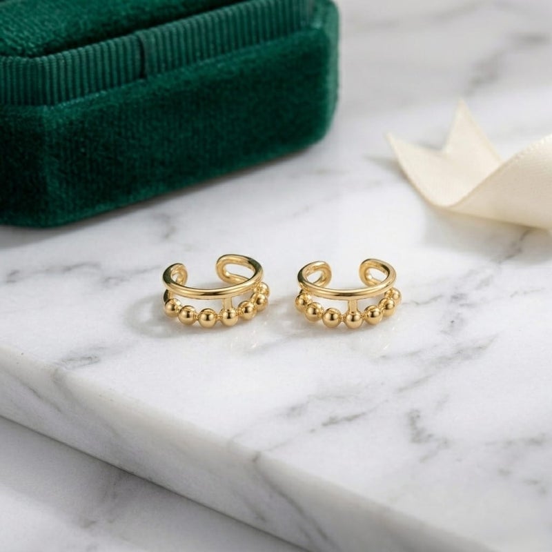 These distinctive gold earrings feature a row of prominent beads for an elegant and unique look. They require no piercing for easy wear and all-day comfort. - Image 5