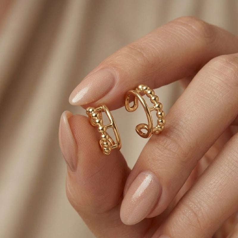These distinctive gold earrings feature a row of prominent beads for an elegant and unique look. They require no piercing for easy wear and all-day comfort. - Image 4