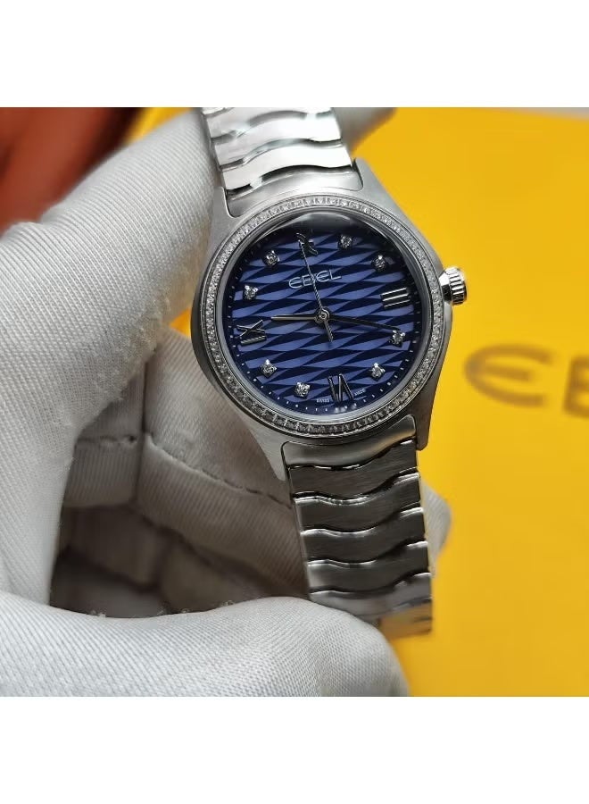 The Ebel women's watch features a classic design with a distinctive wave-shaped strap.