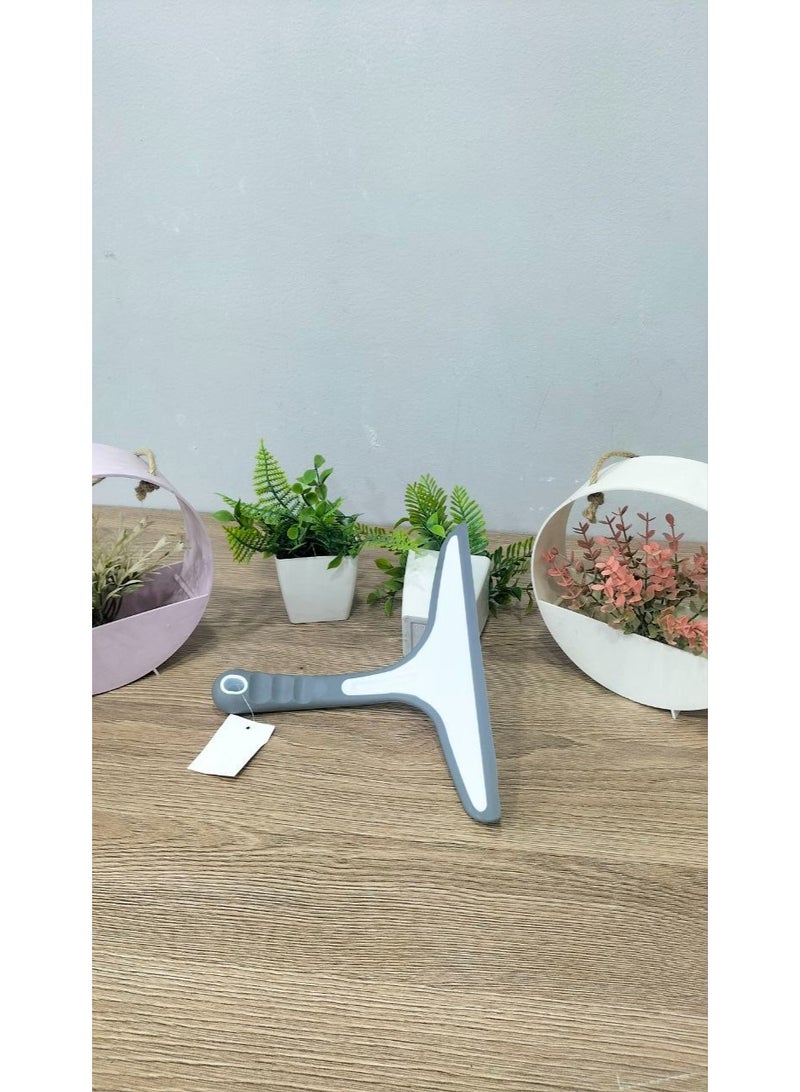 A glass squeegee that helps remove water and soap residue quickly and efficiently. - Image 2