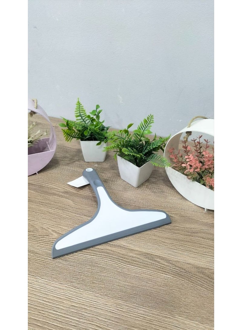 A glass squeegee that helps remove water and soap residue quickly and efficiently. - Image 3