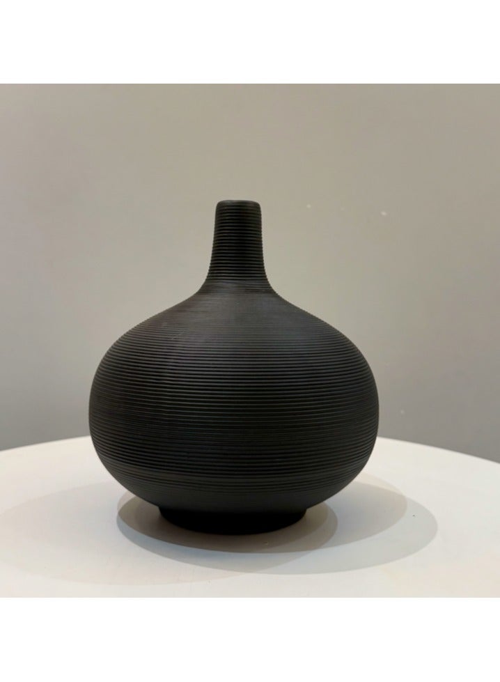This black hand-sanded flower pot vase is crafted from durable resin with a beautifully cast design, perfect for displaying your favorite flowers or greenery. It makes a statement piece for your living room, bedroom, or dining room, reflecting your sophisticated taste. Dimensions: 20cm high x 17cm wide.  - Image 1