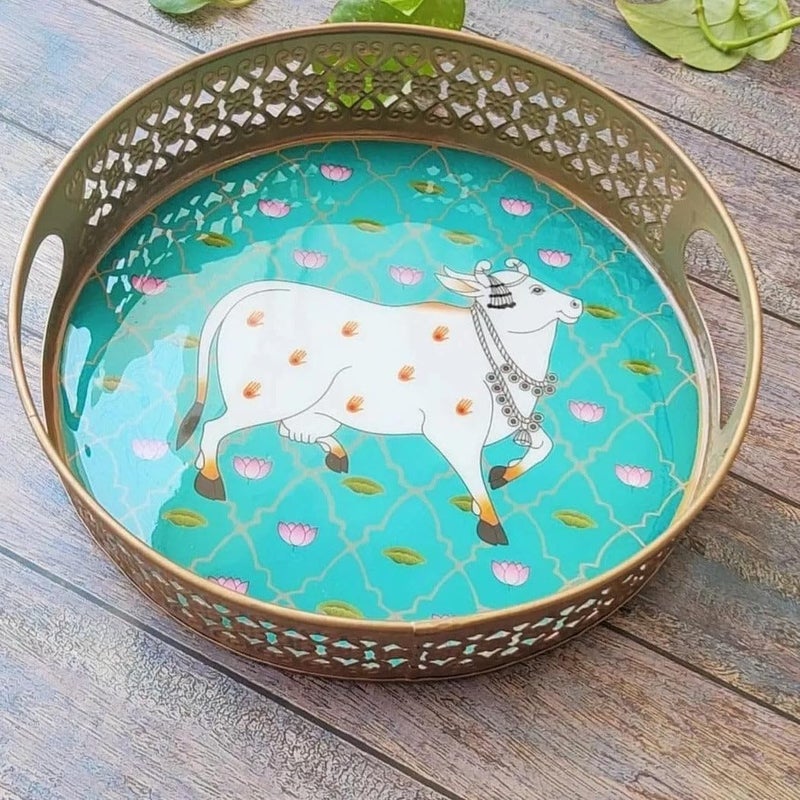 G K EXCLUSIVE™ Round Metal Tray with Pichwai Art of Nandi | Cow Pichwai Tray | Best for Home Decor, Wedding Gift, Diwali Gift and Multiuse | High Glossy Raisen Work (Randaom Color & Design) (10") - Image 1