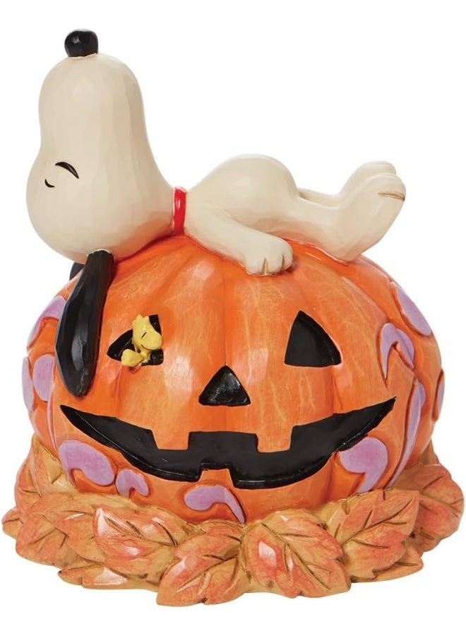 Enesco Enesco Jim Shore Peanuts Halloween Snoopy Laying on Carved Pumpkin Figurine, 5.5 Inch, Multicolor  - Image 1