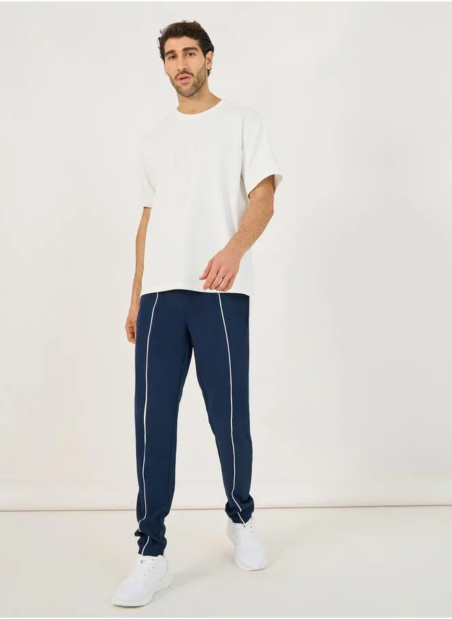 ستايلي 4-Way Stretch Compression Knit Slim Track Pants with Piping Detail