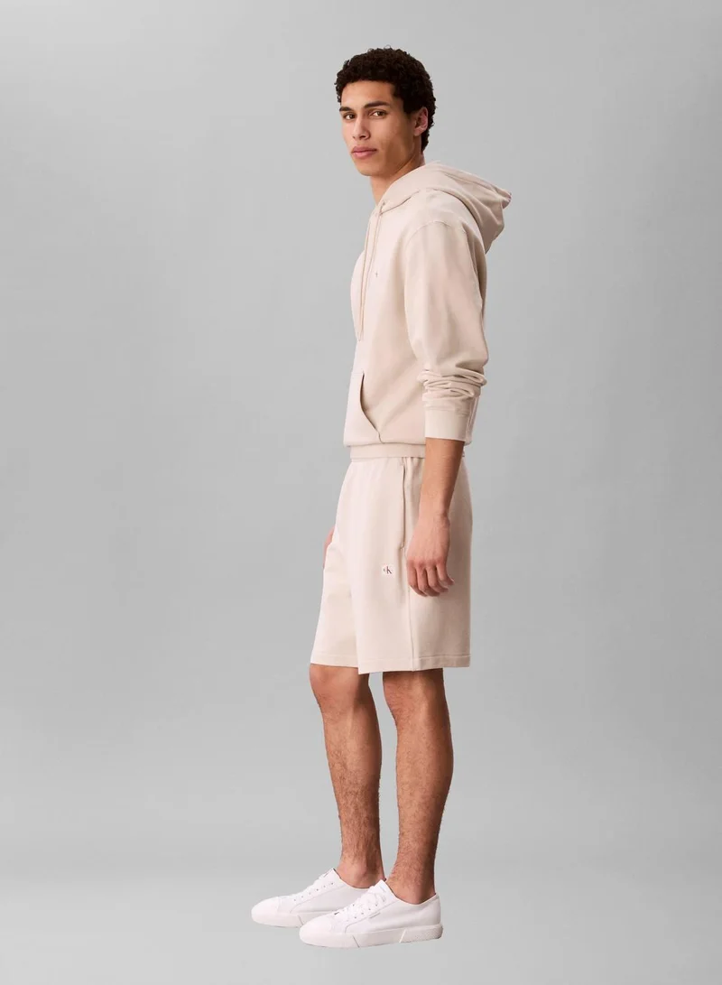 Calvin Klein Jeans Oatmeal Cotton Terry Badge Jogger Shorts for Men | Best Price UAE