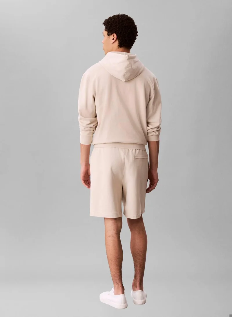 Calvin Klein Jeans Oatmeal Cotton Terry Badge Jogger Shorts for Men | Best Price UAE