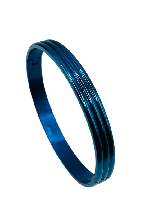 Elevate your accessory collection with this striking Triple Groove Metallic Blue Bangle Bracelet. Crafted from premium stainless steel, this modern piece features an eye-catching design with three parallel grooves that create a sophisticated dimensional effect. The stunning metallic blue finish adds a contemporary touch while maintaining a timeless appeal. The bangle's smooth, seamless construction ensures comfortable all-day wear, while its durable stainless steel composition offers excellent resistance to tarnishing and wear. Perfect for both casual and formal occasions, this bracelet can be worn alone as a statement piece or stacked with other bangles for a more dramatic look. The sleek design and premium craftsmanship make it an ideal choice for those who appreciate modern, minimalist aesthetics. Its versatile style complements any outfit, from business attire to evening wear, making it a valuable addition to your jewellery collection.