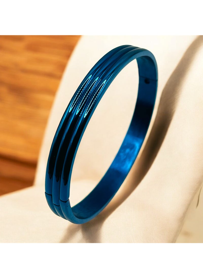 Elevate your accessory collection with this striking Triple Groove Metallic Blue Bangle Bracelet. Crafted from premium stainless steel, this modern piece features an eye-catching design with three parallel grooves that create a sophisticated dimensional effect. The stunning metallic blue finish adds a contemporary touch while maintaining a timeless appeal. The bangle's smooth, seamless construction ensures comfortable all-day wear, while its durable stainless steel composition offers excellent resistance to tarnishing and wear. Perfect for both casual and formal occasions, this bracelet can be worn alone as a statement piece or stacked with other bangles for a more dramatic look. The sleek design and premium craftsmanship make it an ideal choice for those who appreciate modern, minimalist aesthetics. Its versatile style complements any outfit, from business attire to evening wear, making it a valuable addition to your jewellery collection.