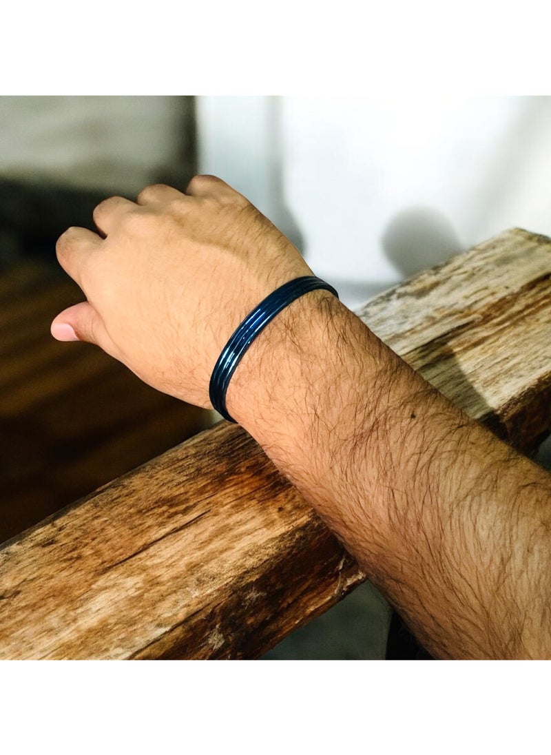 Elevate your accessory collection with this striking Triple Groove Metallic Blue Bangle Bracelet. Crafted from premium stainless steel, this modern piece features an eye-catching design with three parallel grooves that create a sophisticated dimensional effect. The stunning metallic blue finish adds a contemporary touch while maintaining a timeless appeal. The bangle's smooth, seamless construction ensures comfortable all-day wear, while its durable stainless steel composition offers excellent resistance to tarnishing and wear. Perfect for both casual and formal occasions, this bracelet can be worn alone as a statement piece or stacked with other bangles for a more dramatic look. The sleek design and premium craftsmanship make it an ideal choice for those who appreciate modern, minimalist aesthetics. Its versatile style complements any outfit, from business attire to evening wear, making it a valuable addition to your jewellery collection.