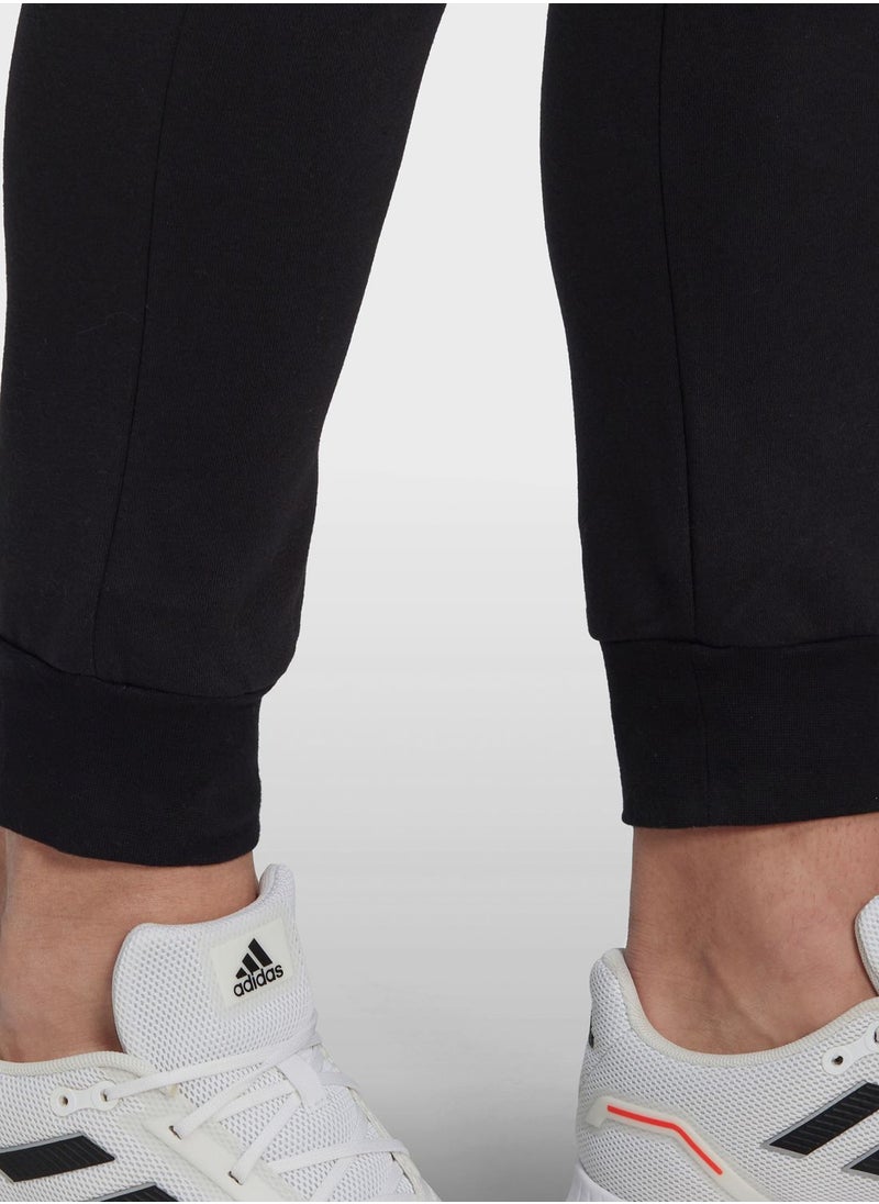 اديداس - Essentials Fleece Regular Tapered Pants - Image 1