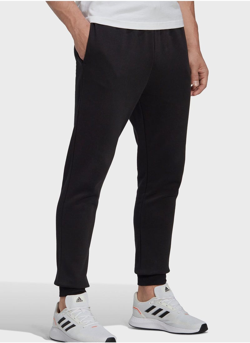 اديداس - Essentials Fleece Regular Tapered Pants - Image 1