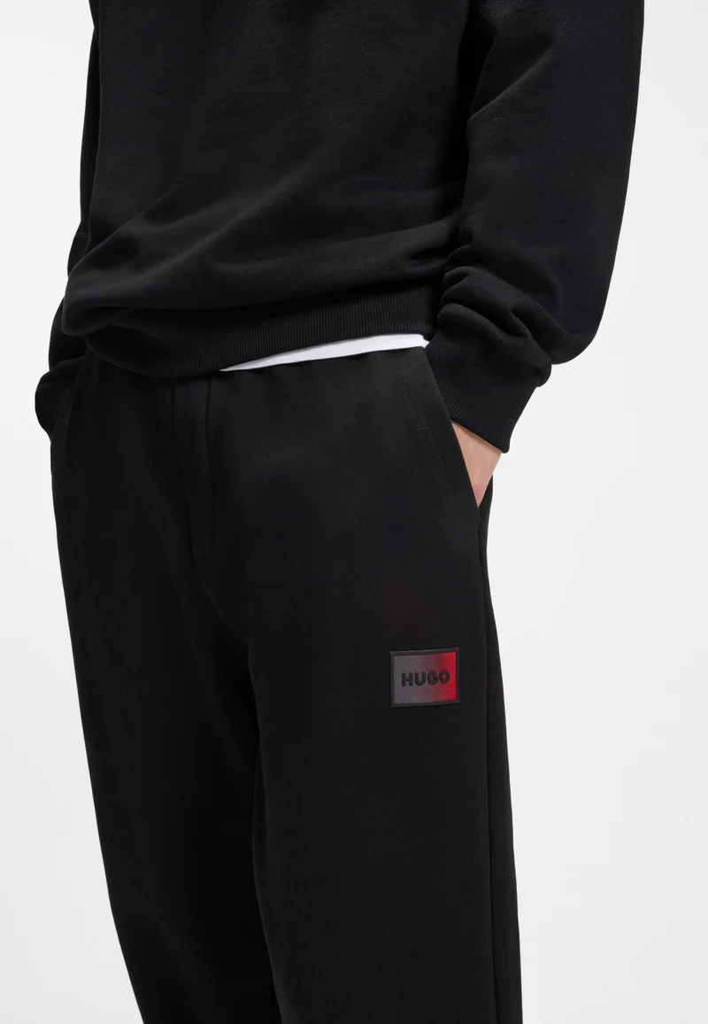 HUGO Black Cotton-terry tracksuit bottoms with gradient logo for Men | Best Price UAE