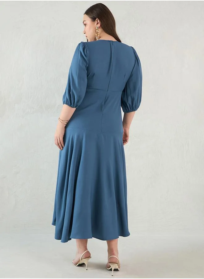 فيميلا Plus Size Solid Wrap Look A-Line Midi Dress by Styli