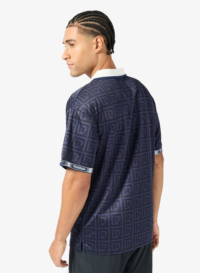 ريبوك قميص كرة قدم بولو بتصميم مونوجرام