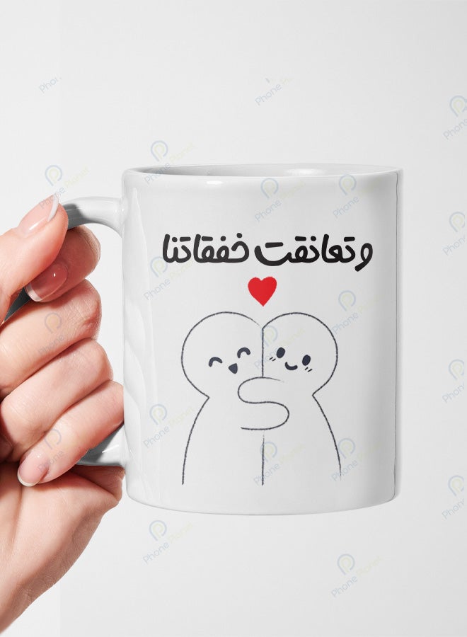 A ceramic mug printed with the phrase Our heartbeats embraced and featuring a comfortable handle