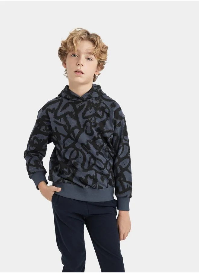 ديفاكتو All-Over Print Oversized Hooded Sweatshirt by Styli