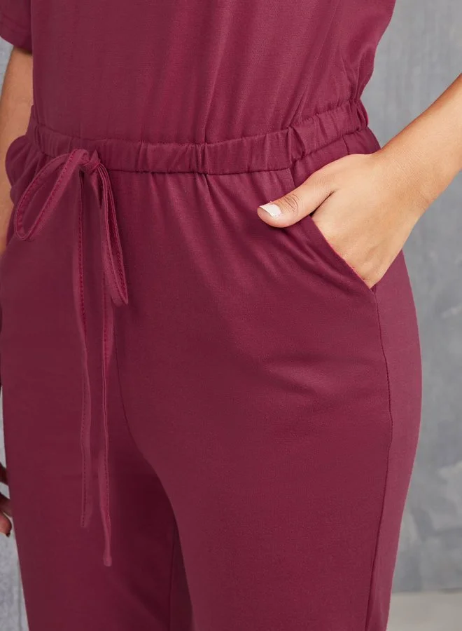 Take Two Button Up Solid Jumpsuit with Elastic Waist Tie Up