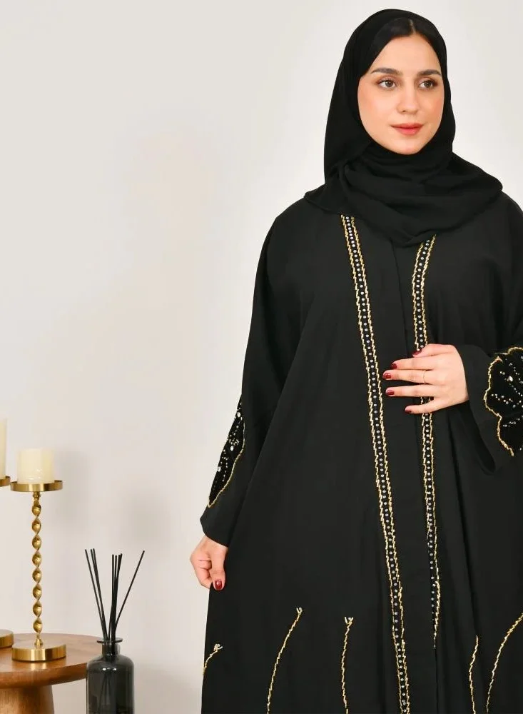 lamha abaya Black wrap abaya with prominent embroidery and black velvet overlay on flowers