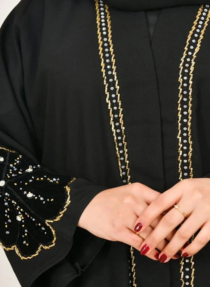 lamha abaya Black wrap abaya with prominent embroidery and black velvet overlay on flowers