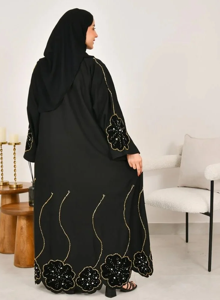 lamha abaya Black wrap abaya with prominent embroidery and black velvet overlay on flowers
