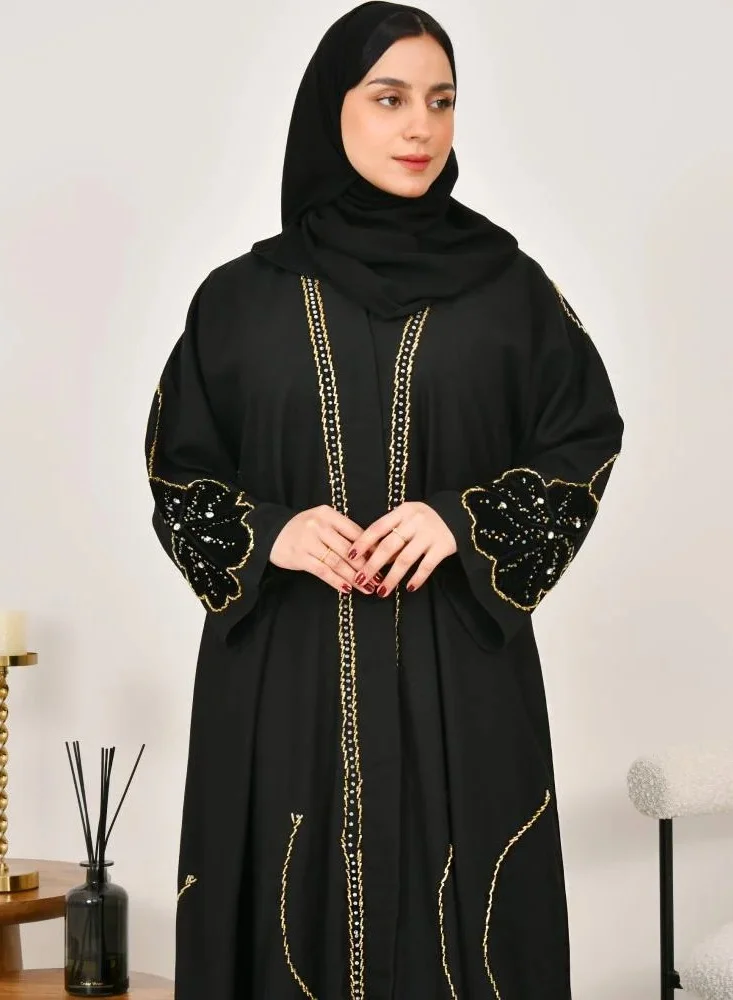 lamha abaya Black wrap abaya with prominent embroidery and black velvet overlay on flowers