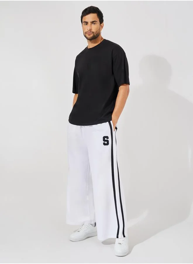 ستايلي Premium Side Tape Wide Leg Joggers with Embroidery Badge