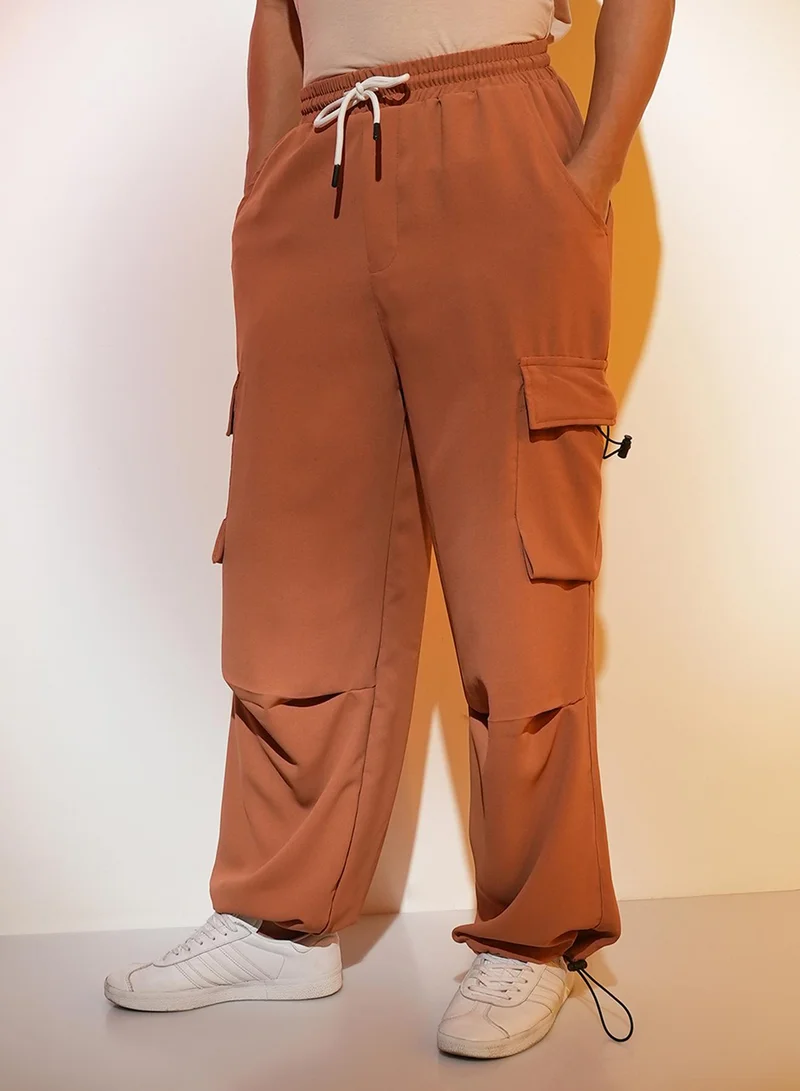 Campus Sutra Men's Sienna Brown Solid Cargo Parachute Trousers