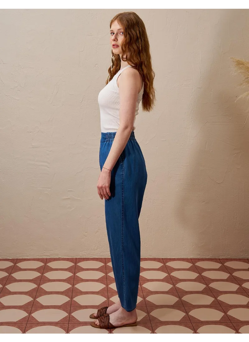 Kayra High-Waisted Elasticated Tapered Lyocell Pants Indigo