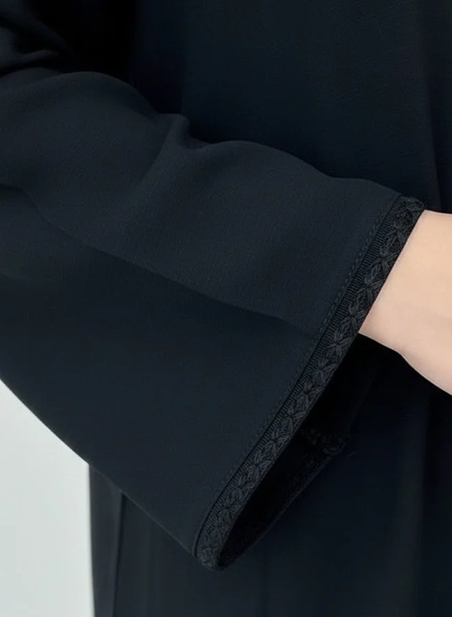 HAWRAA ABAYA Black girls’ abaya adorned with elegant black trim