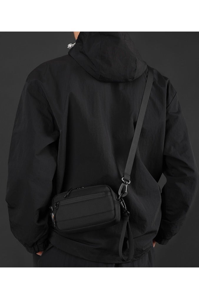 Tactical Sling Bag for Men & Women, Rugged 1680D Ballistic Nylon Crossbody Bag, Water-Repellent & Durable EDC Pack. This compact rectangle-shaped sling bag features an intelligently organized interior with a large main pocket, internal compartments, key hook, and specialized pockets for secure storage. The highly adjustable and detachable strap allows multiple carry modes: as a crossbody bag, over the shoulder, around the waist, or as a sleek clutch using the top handle/wrist strap. Ideal for urban navigation, work commute, weekend hiking, travel, and tactical operations. Built to last with a focus on functionality, security, and a modern tactical style. This versatile companion keeps your essentials like phone, wallet, tools, and valuables organized and within easy reach. Redefine your everyday carry with this smart, adaptable, and sturdy unisex bag. Perfect for outdoor enthusiasts, professionals, students, and anyone seeking a reliable and stylish hands-free solution. Key features in