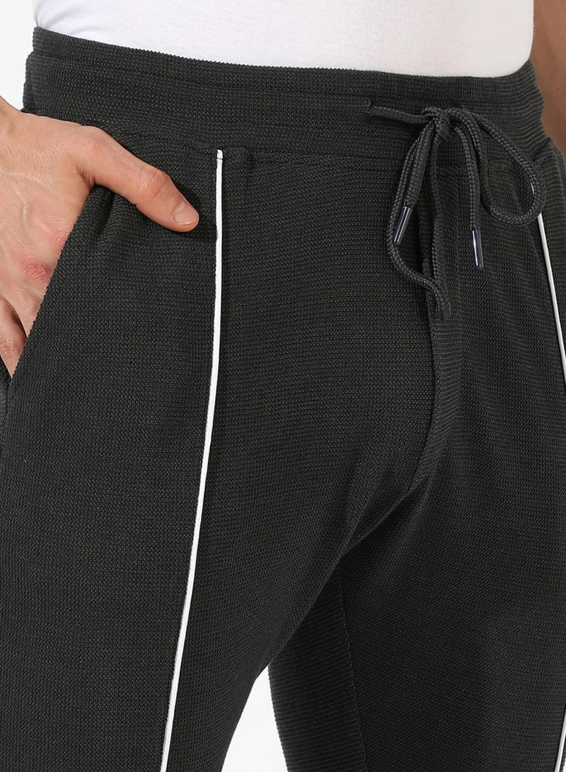 Campus Sutra Campus Sutra Men's Solid Black Regular Fit Trackpants For Casual Wear | Angled Open Pockets | Drawstring Waist | Trackpants Crafted With Comfort Fit & High Performance For Everyday Wear