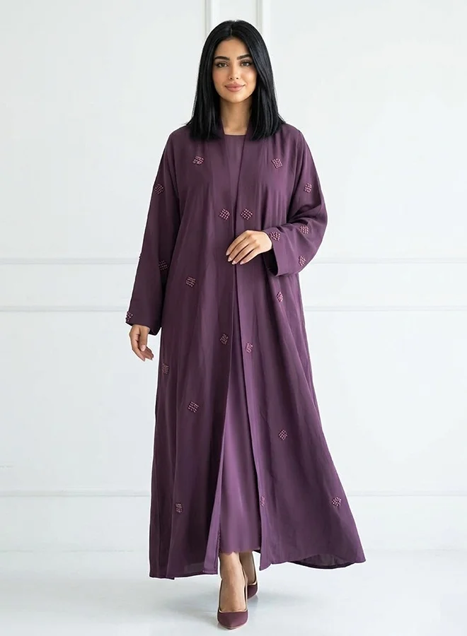 Hawraa Abaya Purple wrap abaya featuring prominent embroidery across the entire abaya